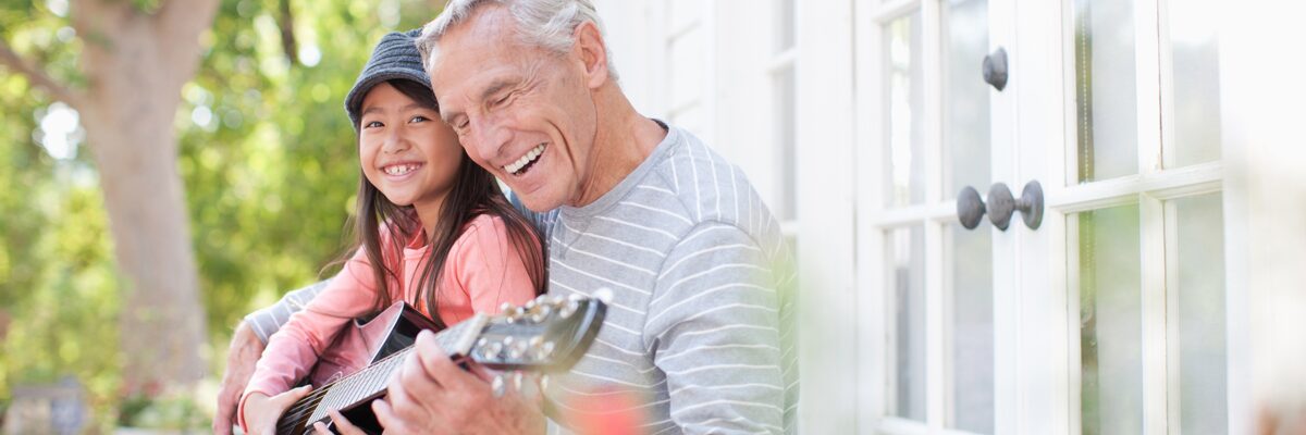 Grandpa play guitar with grandaughter