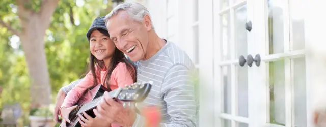 Grandpa play guitar with grandaughter