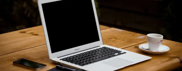 Computer and coffee copy on table